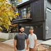 Visionary Husbands in front of black square house