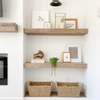 Brittany McNab designed corner featuring photo frames, baskets and timeless design