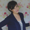 Jennifer Woch Jennifer Woch against floral wallpaper wall wearing navy jacket over light blouse