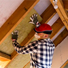 insulation being installed by trades person insulation being installed by trades person