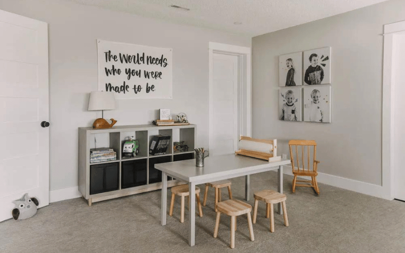 white kids room with black and white posters and light wood bar stools