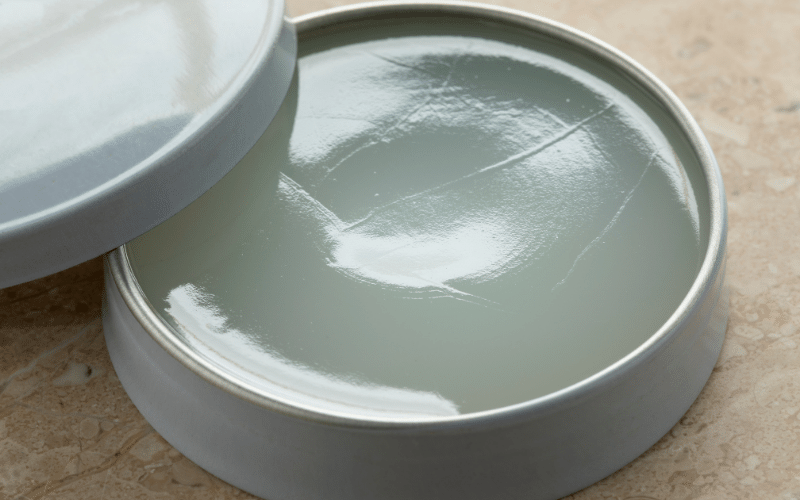 open silver tin of petroleum jelly on counter top
