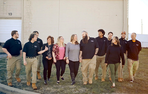 The Snappy Services team walking towards the camera outdoors.