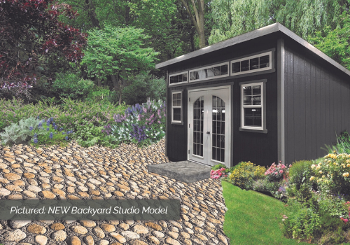 Charcoal grey ProShed backyard shed render cobblestones and garden