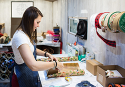 person wrapping Christmas gift person wrapping Christmas gift