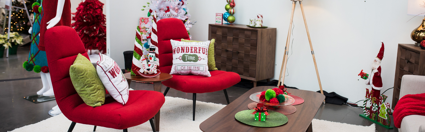 Holiday Boutique designer space with holiday decor and red living room chairs 